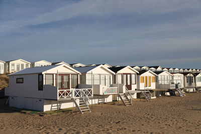 Houses on beach  against sky