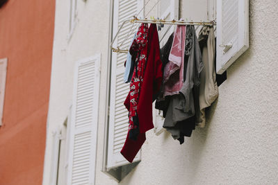 Low angle view of clothes drying against building