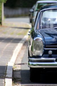 Close-up of car on road