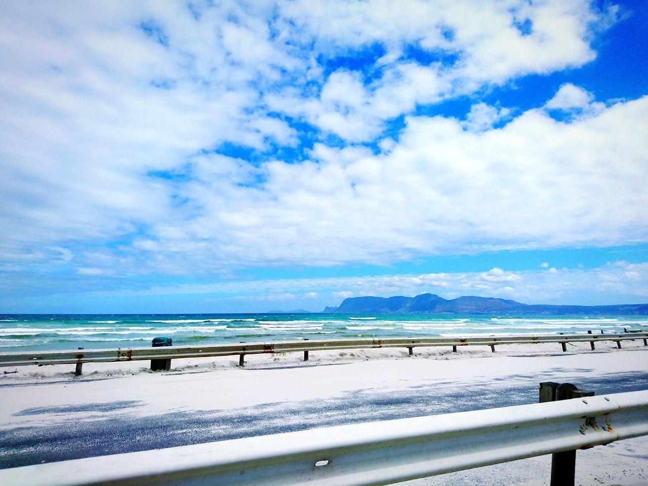 SCENIC VIEW OF BEACH AGAINST BLUE SKY