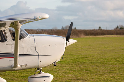 Airplane on field against sky