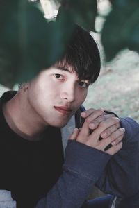 Portrait of young man sitting outdoors