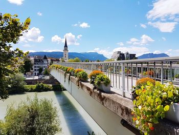 View of buildings in city against cloudy sky
