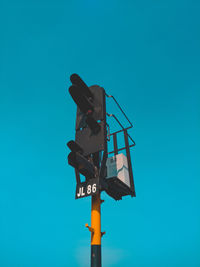 Low angle view of information sign against blue sky