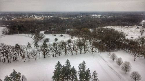 High angle view of snow covered land against sky