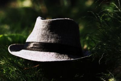 Close-up of person wearing hat on field