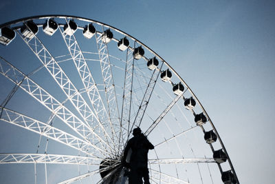 Low angle view of ferris wheel against sky