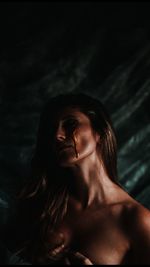 Portrait of beautiful young woman in swimming pool