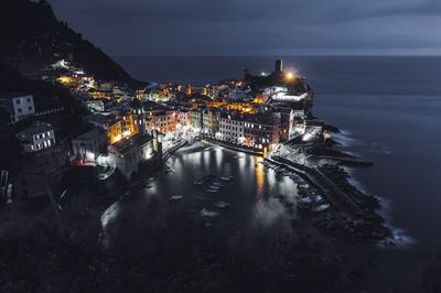 High angle view of buildings by sea in vernazza at night