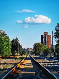 View of railroad tracks against blue sky