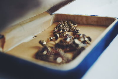 Close-up of old-fashioned jewelry in box on white background
