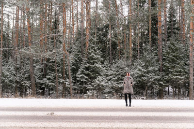 Rear view of woman walking in forest