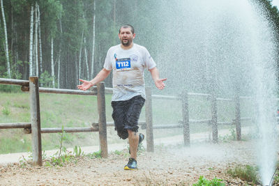 Full length of young man running on plants