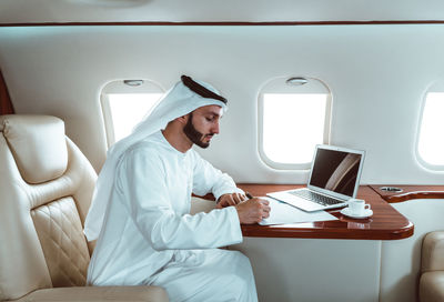 Businessman working in airplane