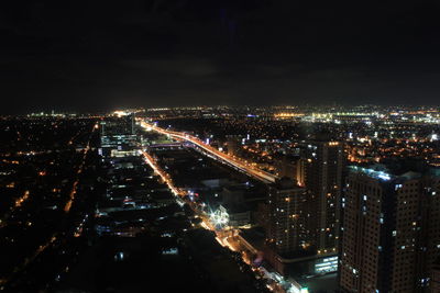 High angle view of illuminated buildings in city at night