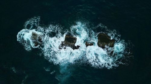 High angle view of water splashing on rocks