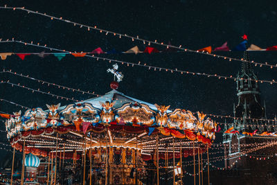 Magic holiday in moscow. festive children's merry go round carousel fun in the new year atmosphere