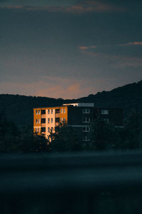 Buildings against sky at dusk