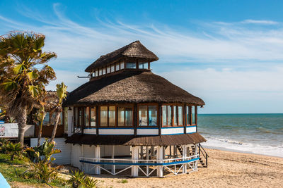 Lifeguard hut on beach against sky