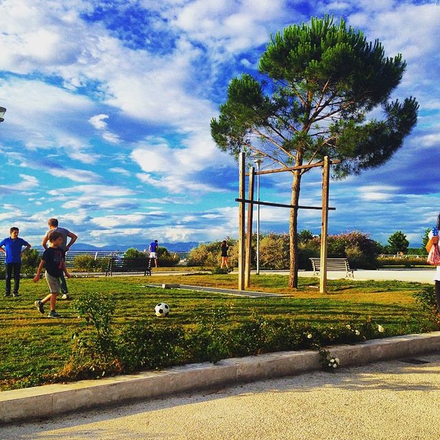 sky, tree, cloud - sky, grass, cloud, lifestyles, men, leisure activity, person, full length, cloudy, green color, walking, day, park - man made space, growth, sunlight, field, nature