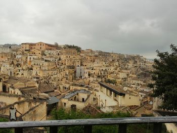 Buildings in town against sky