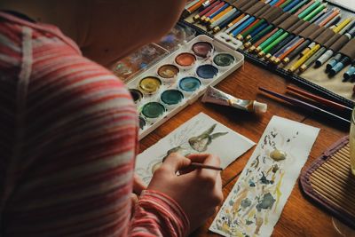 Cropped image of woman painting easter bunny