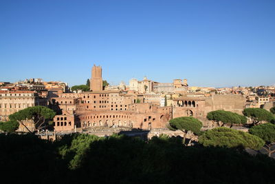 Buildings in town against blue sky