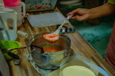 Cropped hand of man preparing food