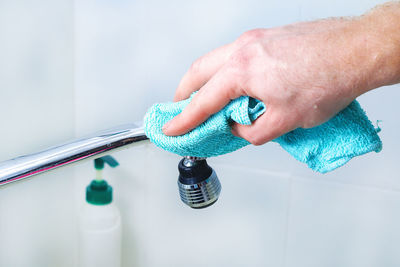 Cropped hand of doctor holding thermometer