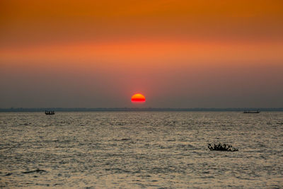 Scenic view of sea against romantic sky at sunset