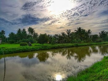 Scenic view of lake against sky at sunset