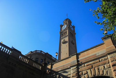 Low angle view of clock tower against sky