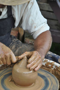 Midsection of man working in mud