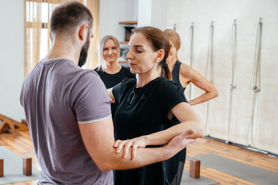 People doing yoga at gym