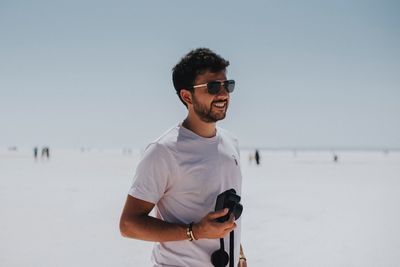 Man photographing while standing at beach