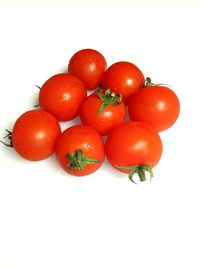 Close-up of tomatoes over white background