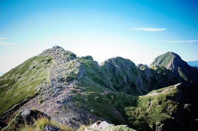Scenic view of mountains against blue sky