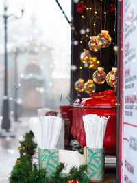 Christmas fair street food stall red pot mulled wine hot drink holiday market illuminated decoration