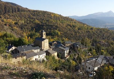 Houses on mountain against clear sky