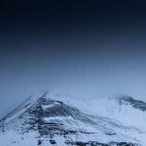 Scenic view of snowcapped mountains against clear sky