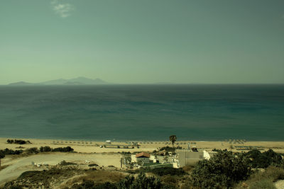 High angle view of sea and buildings against sky