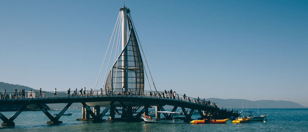 View of bridge over river against clear sky