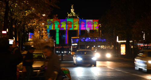 Cars on city street at night