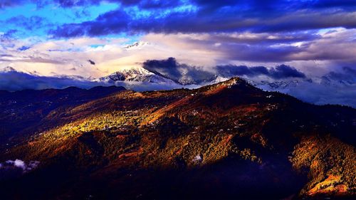Scenic view of mountains against cloudy sky
