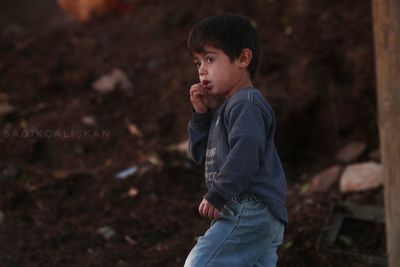 Side view of boy looking away outdoors