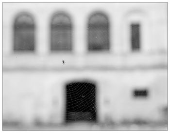 Reflection of people on window of building