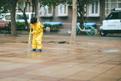 Front view of boy playing in the rain