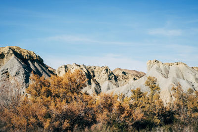 Rock formations on landscape against sky