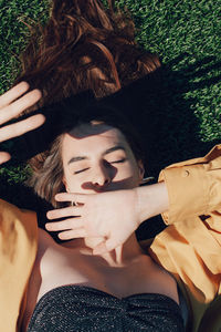 High angle view of woman sleeping on grass