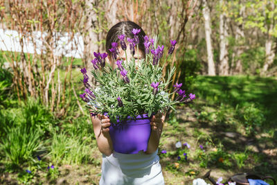 Rear view of woman holding flowers